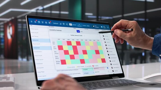 Man Analyzing Data On Laptop In Office
