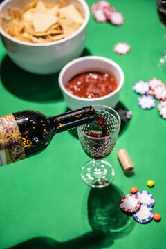 Pouring red wine at a poker game night