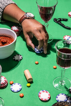 Hand placing poker chips on green table