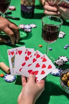 Holding playing cards during a fun poker game