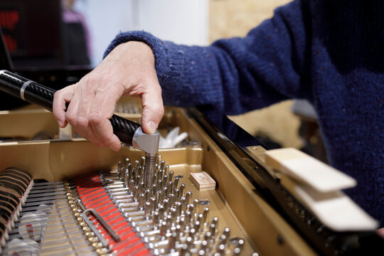 Close up of piano tuning with wrench tool