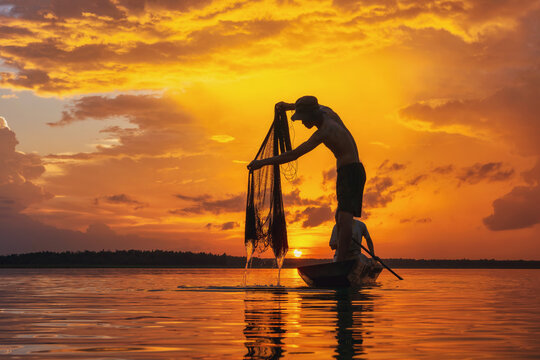 Silhouetted Laguna fisherman casts net at sunset