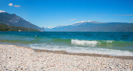 Toscolano beach, lake Gardasee, view to Montebaldo mountain, summer in italy