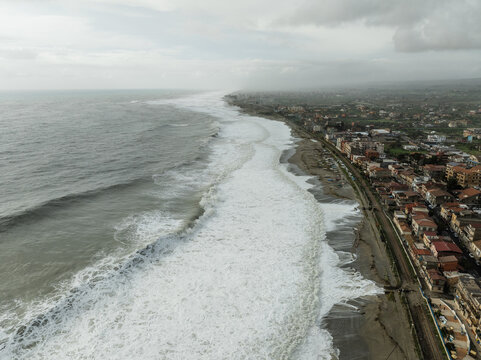 Storm surge destroys homes and buildings near the beach, ocean waves raging