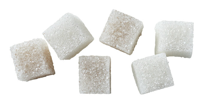 Overhead shot of six white sugar cubes scattered against a black background