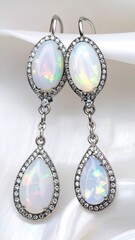 Elegant Opal Drop Earrings with Diamond Accents on Silk.