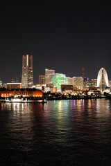 Fototapeta premium Night view of Minato Mirai Yokohama with illuminated Ferris wheel and houseboat