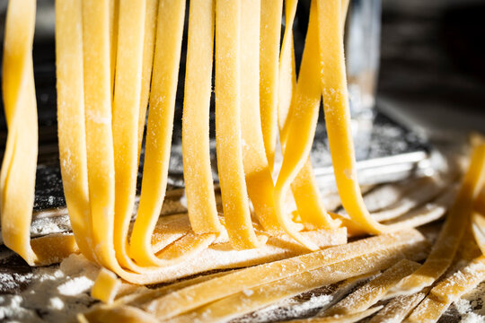 Fresh raw noodles made on home pasta machine closeup low angle view