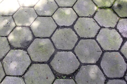Top view close up of hexagonal paving blocks.
Hexagon-patterned concrete floor.
