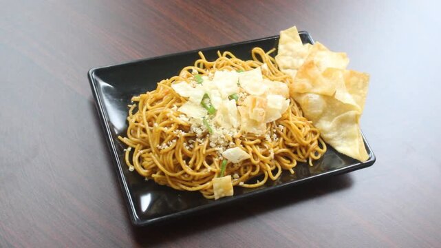 Authentic Indonesian Mie Goreng Fried Noodles with Crispy Wontons and Savory Toppings