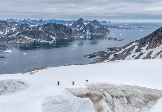 Greenland, Sermersooq, Kulusuk, Schweizerland Alps, three people walking in snow