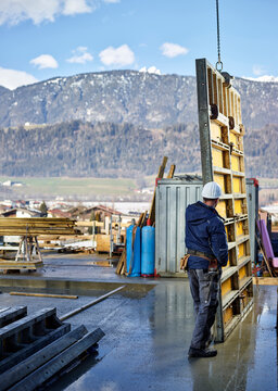 Construction worker positioning plywood