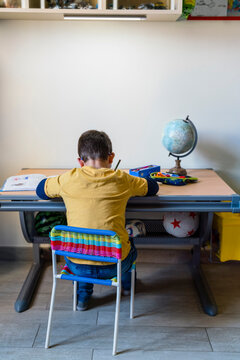 Student studying while sitting at desk during quarantine homeschooling