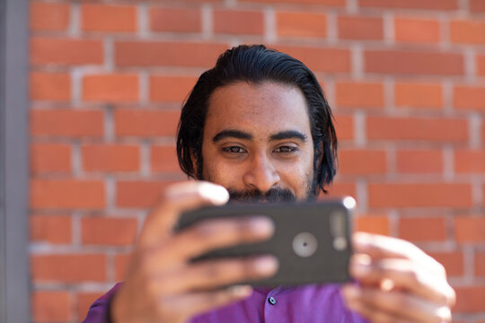 Young man taking a selfie with his smartphone