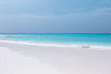 Fototapeta premium Vacation summer holidays leisure background - sunny tropical Caribbean paradise resort beach with white sand, lounger, palms on Maldive