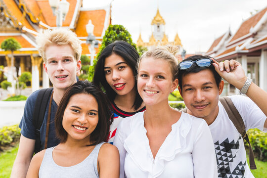 Thailand, Bangkok, group picture of five friends visiting temple complex