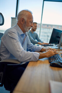 Senior businessman using computer in office