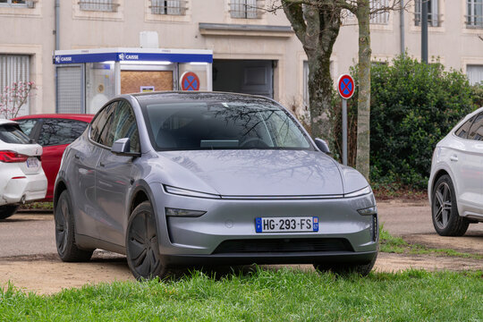 Nancy, France - December 13th 2025 : View on a grey Tesla Model Y Juniper parked on a parking lot. This is a compact electric crossover produced since 2020 by Tesla Inc.