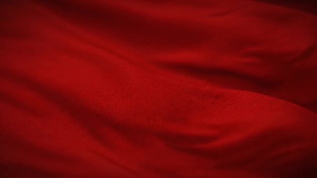 Luxurious red satin fabric waves create a smooth silk texture and flowing drapery design for a soft velvet material backdrop perfect for Valentine decoration