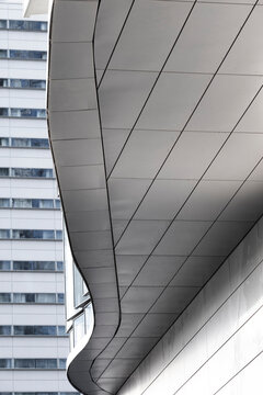 Minimal modern architecture showing an urban building facade in metal with a smooth curve and clean lines for strong perspective and a polished background with copy space