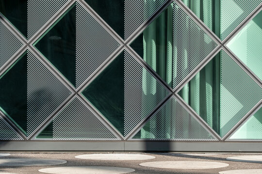 Abstract urban facade in modern glass showing geometry grid pattern and rich texture made for a clean background with corporate feel and generous copy space