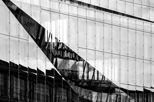 Modern urban facade architecture with glass reflection lines and abstract geometry in monochrome style designed as a refined corporate background with copy space