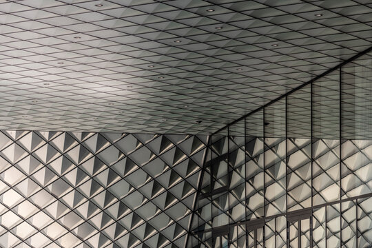 Abstract modern interior architecture showing ceiling grid pattern with texture and deep perspective creating a calm background for corporate design and copy space