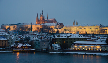 Fototapeta premium A view on the Prague Castle and Little Quarter from the Charles Bridge in winter under snow