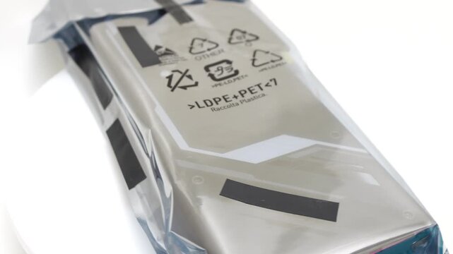 Antistatic bag electronic component in silver metallic packaging rotating on white background to show protective industrial shipping materials for hardware