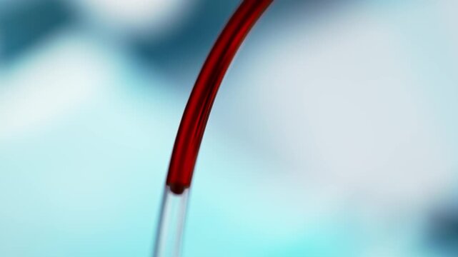 Blood Transfusion Through A Transparent Tube on a Blurred Blue Hospital Background, Red Fluid In Macro And Slow Motion