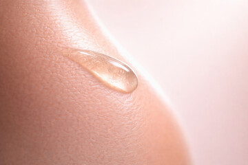 Fototapeta premium Hydration meets luxury in this skincare image showcasing smooth texture of serum drop on skin, emphasizing essence of beauty