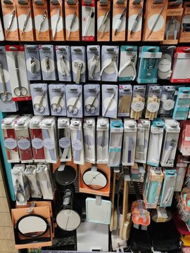 Saujon, France - January 24, 2026: Intermarche. Assorted grooming tools displayed on shelves in retail packaging, including scissors, combs, and mirrors in a beauty supply store