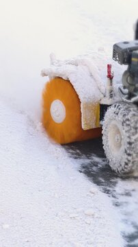 Removing snow with portable blower machine during winter, worker with gas snow blower removal in the streets after snowfall, clearing residential sidewalk driveway with snow sweeper, snowplow machine