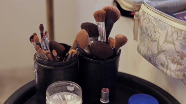 Close-up shot of professional makeup brushes and bridal beauty accessories on vanity table