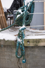 Fototapeta premium Blue Marine Rope Hanging From Pier In Winter
