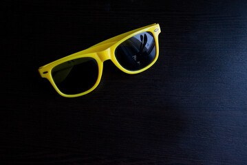 Stylish yellow sunglasses with reflective lenses close view