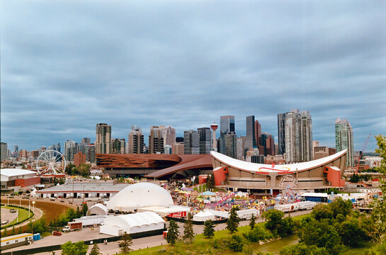 Calgary, Alberta, Canada. Feb 19, 2026. Panoramic view of the Calgary Stampede grounds featuring the Saddledome and BMO Centre under a cloudy sky.