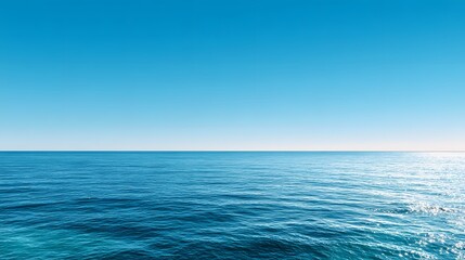 Obraz premium Infinite Blue Horizon: A serene view where the endless expanse of the deep blue sea meets the vast, clear sky, creating a sense of peace and tranquility.