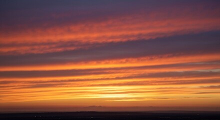 Striated sunset showcasing fiery orange and red hues across a textured, layered, dusk sky