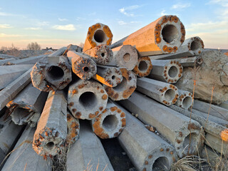 Old reinforced concrete lighting poles at the junkyard