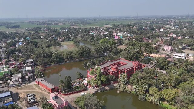 Aerial shot of a beautiful Bengali village with a red-colored Zamindar badi