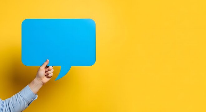 A person holding a blue speech bubble in front of a vibrant yellow background with a blank space for text or message