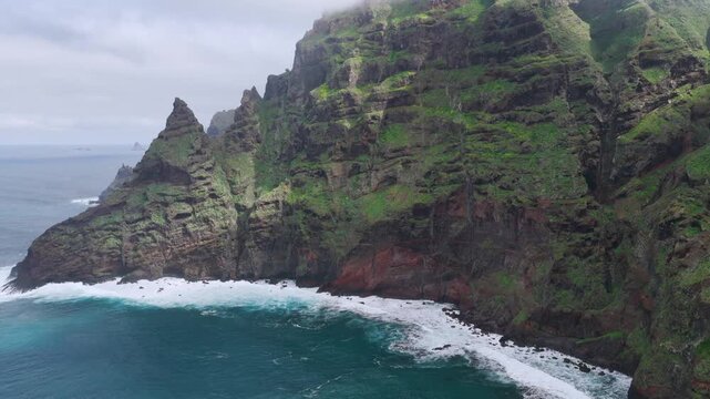 Aerial tracking shot over the rugged Anaga Massif peaks and the prehistoric barrancos of Punta del Hidalgo