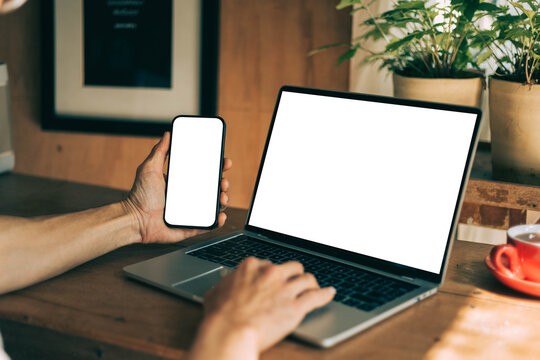 computer screen,mobile phone blank mockup.work using laptop texting cell phone.white background for advertising,contact business search information on desk.marketing,design