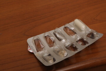 Last white capsule in empty medication blister pack