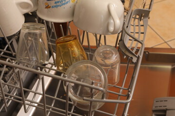 Dish rack loaded with clean glasses and cups