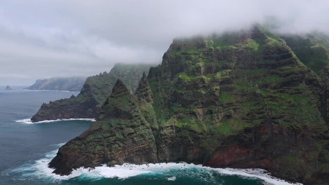 Aerial tracking shot over the rugged Anaga Massif peaks and the prehistoric barrancos of Punta del Hidalgo