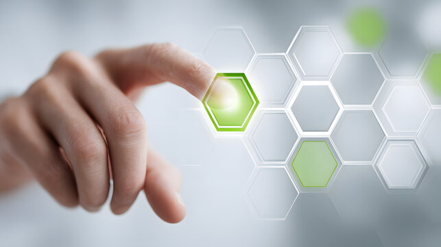 Hand touching glowing hexagon on digital screen