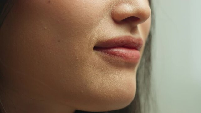 Close up female lips kissing air kiss fooling love gesture Asian unknown woman girl girlfriend wife model with lip lipstick natural makeup moisturizing balm cosmetology dermatology healthy beauty face