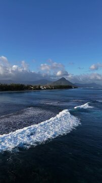 Vertical Aerial View of Flic en Flac Coastline, Mauritius with Breaking Waves and Le Morne Brabant